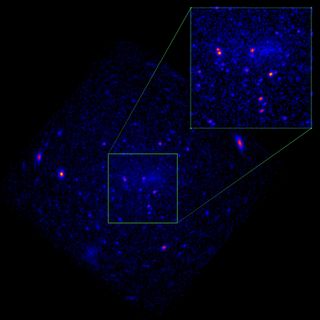 A dark image of an oblong purple blob in space.  Two areas are highlighted with white squares.